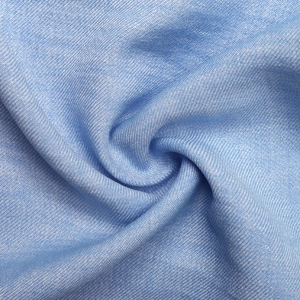 Macro shot of light blue twill weave fabric texture with silk-like glossy finish