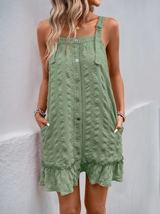 Detail of sage green textured fabric with front buttons and ruffled hem on romper
