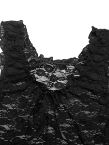 Close-up of black floral lace fabric featuring a delicate satin ribbon bow detail