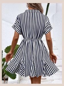 Back view of blue and white striped summer dress showing waist cinching and A-line cut