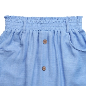 Detail of light blue cotton skirt featuring elastic high waist and vintage wooden buttons