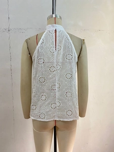 Detailed back view of white floral embroidered lace halter top with button closure detail