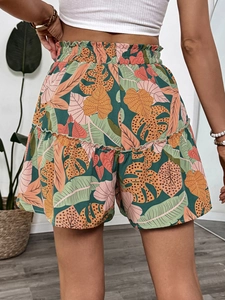Detail of tropical plant print shorts with ruffled hem and comfortable elastic waist