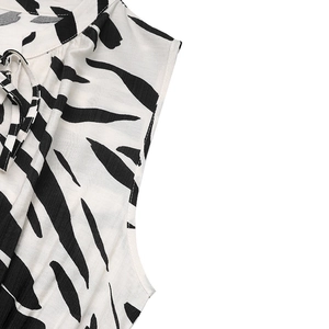 Detailed view of the V-neck with lace-up ties and black zebra print on the dress