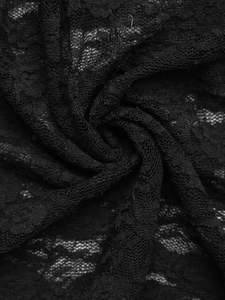 Close-up of intricate black floral lace fabric with delicate embroidery textures