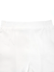 Detailed macro view of white waffle textured elastic waistband on women's casual summer shorts