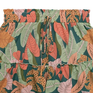 Detail view of tropical leaf print shorts with elastic waist and ruffle hem design
