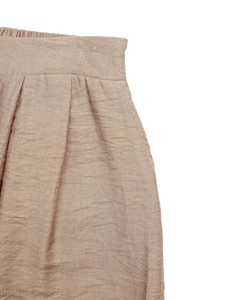 Detail of high-waist linen texture shorts featuring elastic back and functional side pockets