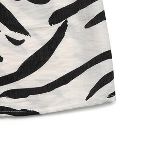 Detailed close-up of the hem stitching and zebra print texture on a sleeveless V-neck dress