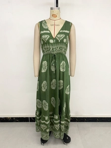 Detail of green ethnic print maxi dress with V-neckline, drawstring waist and ruffled hem