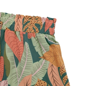 Detail of paperbag waist design on tropical leaf print shorts with elastic waistband