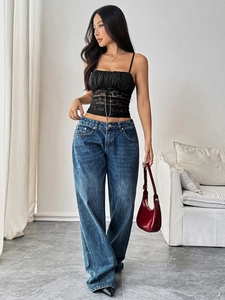 Close-up of black lace camisole with slim fit design and vintage wide leg denim jeans