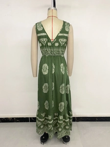 Deep V-neck back view of a bohemian green maxi dress with leaf patterns and ruffles