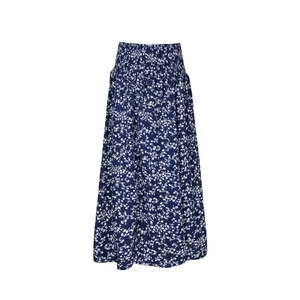 Close-up of smocked high waist detail on navy blue floral print midi skirt
