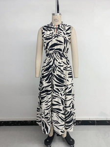 Detail of zebra print sleeveless dress featuring high neck tie and elastic waist