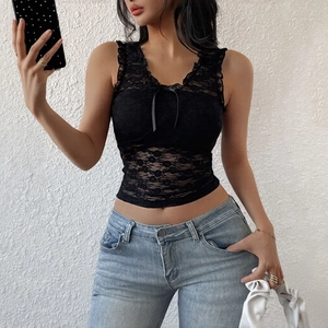 Sexy black lace V-neck sleeveless top with bow detail paired with light blue jeans