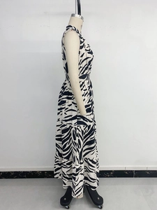 Detail of zebra print sleeveless maxi dress with tiered skirt and elastic waist on mannequin