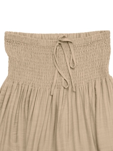 Detail of smocked elastic waistband with drawstring on a khaki A-line maxi skirt