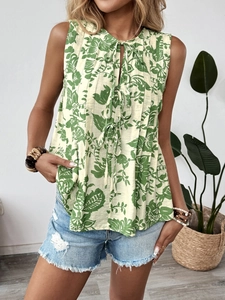 Detail of sleeveless floral shirt with pleated chest and neck ties for a boho look