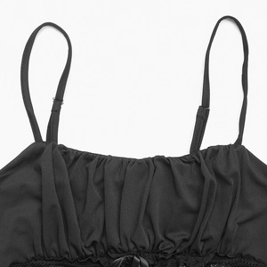 Close-up of black camisole featuring pleated neckline and delicate lace trim with a bow