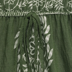 Detail of green floral print dress fabric with cotton-linen texture and drawstring detail