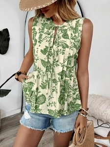 Detail of bohemian pleated sleeveless blouse with green leaf print and tie-neck closure