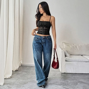 Slim fit black lace camisole top with bow details and stylish vintage wide-leg blue jeans