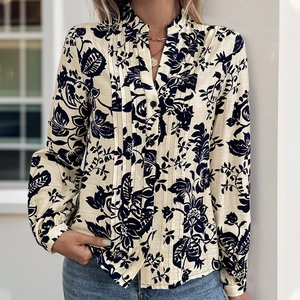 Detailed view of the vintage floral print shirt featuring pleated front and small buttons