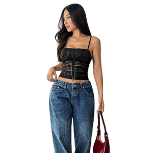 Slim fit black lace camisole paired with blue straight jeans and a red patent leather bag
