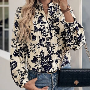 Detail view of vintage floral print shirt featuring pleated front and stand collar texture