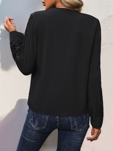 Back view of a black long-sleeve blouse with intricate lace detailing on sleeves