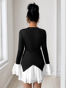 Detail of elegant contrast patchwork dress with white tiered ruffles and V-shaped hem