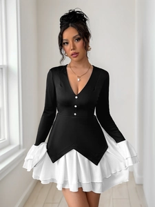 Detail of elegant black V-neck long sleeve dress with white layered ruffle hem and buttons