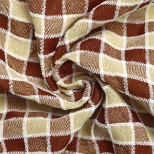 Detailed macro view of woven rust and beige checkerboard fabric with fine textures