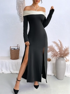 Detail of elegant black off-shoulder evening dress with high side slits and long sleeves
