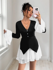 Detailed view of layered white ruffle hem and elegant contrast black stitching on dress