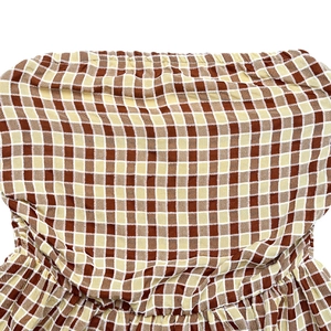 Close-up of brown checkered tube top with elasticated pleated hem and fabric texture