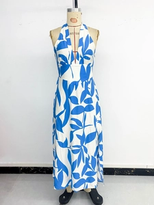 Détail du décolleté en V profond et motif floral bleu sur robe maxi blanche