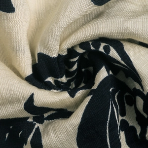 Close-up of pleated retro printed fabric showing texture of long sleeve blouse