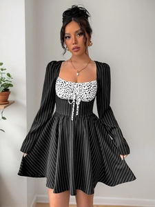 Detail of elegant black and white striped dress with ruched drawstring waist and high waistline