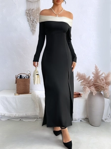 Detail of off-shoulder black and white party dress with side slit and long sleeves