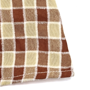 Macro shot of brown checkerboard fabric texture and precise stitching on the hem