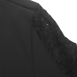 Detail of elegant black blouse showing intricate floral lace sleeve and fine stitching