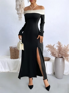 Detail of elegant black off-shoulder maxi dress with white trim and high side slit