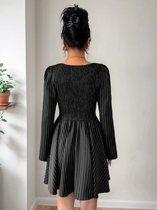 Detail of smocking elastic back design on striped long sleeve black dress for women