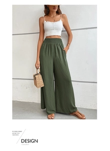 Close-up of army green crinkle fabric and elastic high waist on wide leg trousers