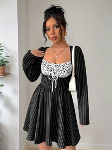 Detail of elegant long sleeve dress with polka dot patchwork and striped pattern texture