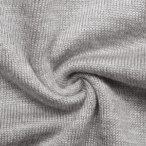 Macro detail of soft light grey knit fabric with fine jersey texture and elegant folds