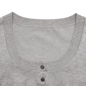 Close-up of gray knit cardigan with ribbed crew neck and black buttons detail