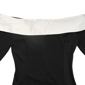 Detail of off-shoulder neckline with contrast white lapel on a black evening dress
